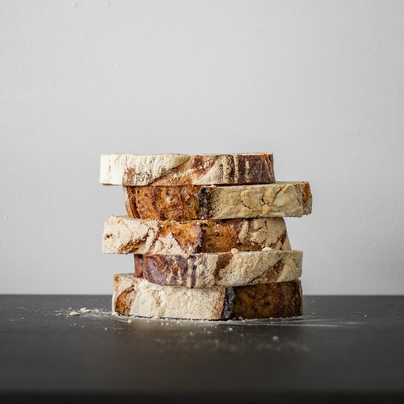 A stack of sourdough slices showing an open crumb.